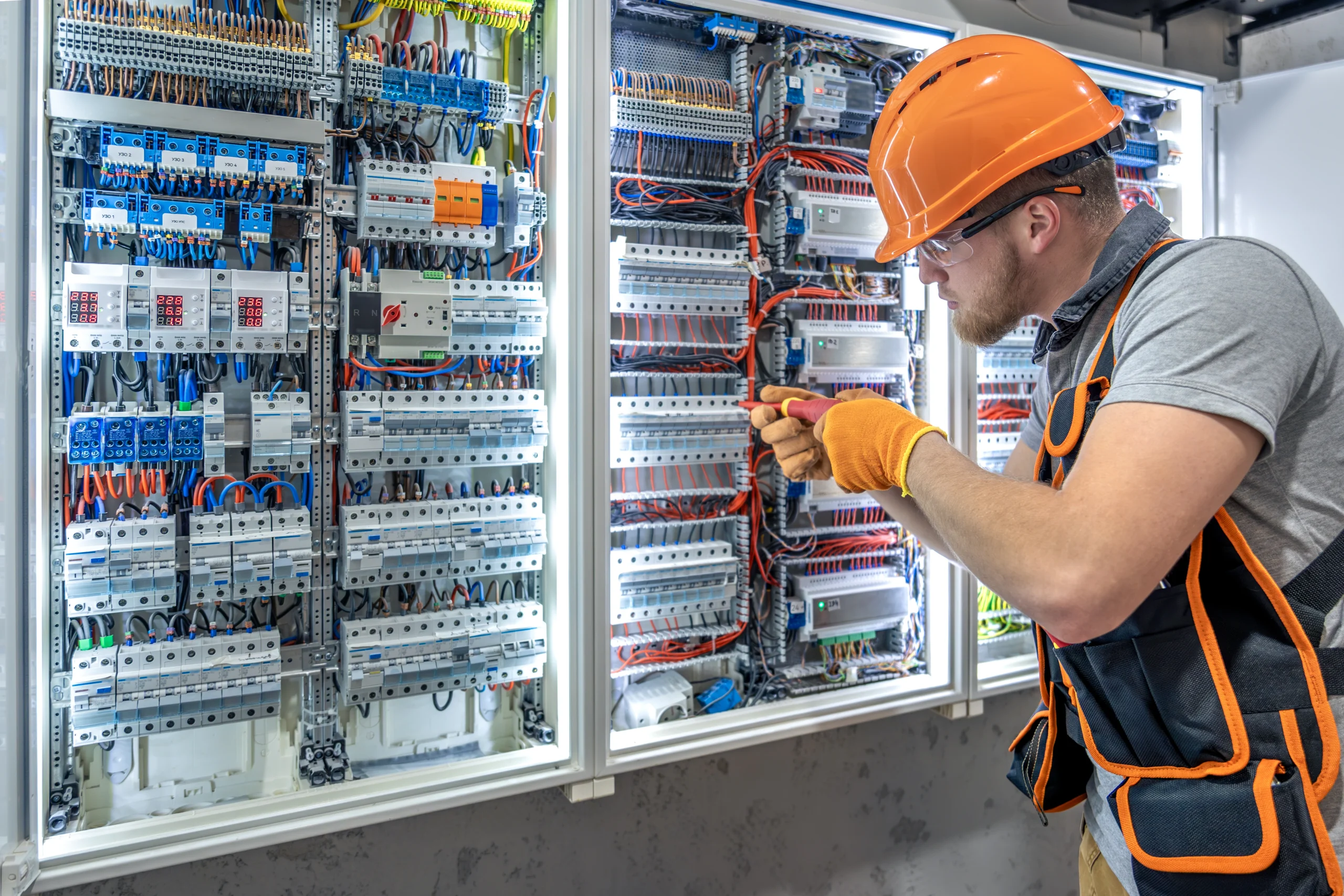 Electrician installing wiring in London property